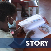 A child reads a book in school