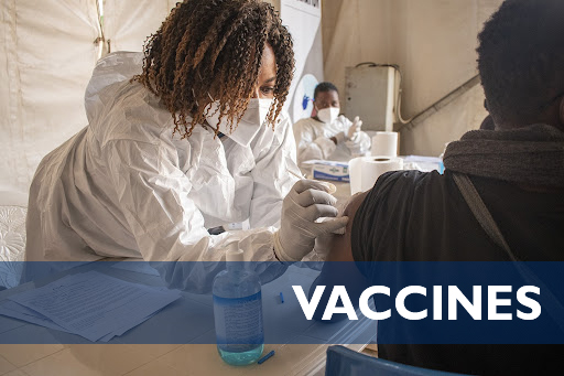 A health care worker administers a vaccine