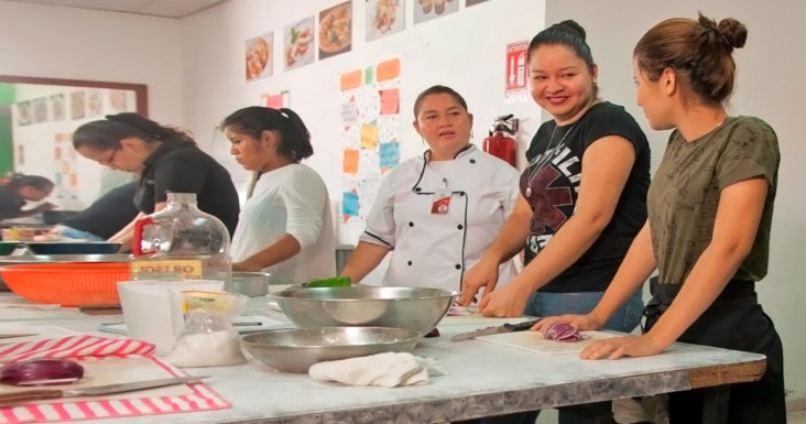 Young women learning culinary skills