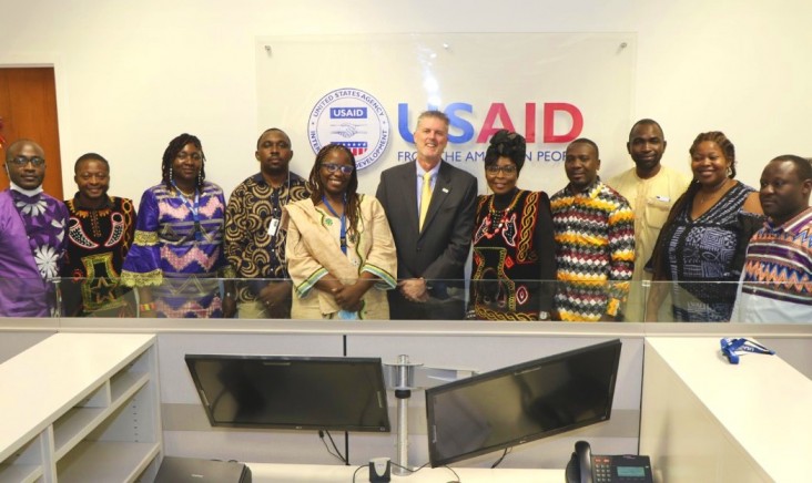 USAID/Cameroon staff standing around the front desk in the office