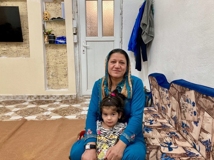 Milkia with her granddaughter in their home in a refugee camp near Dohuk, Iraq