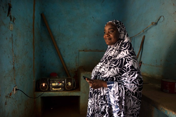 A radio presenter at one of Voices for Peace’s partner stations in Niger listens to a live round table broadcast. Photo credit: Equal Access International/V4P)