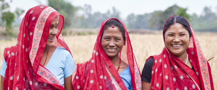 Close up of three women smiling in a field