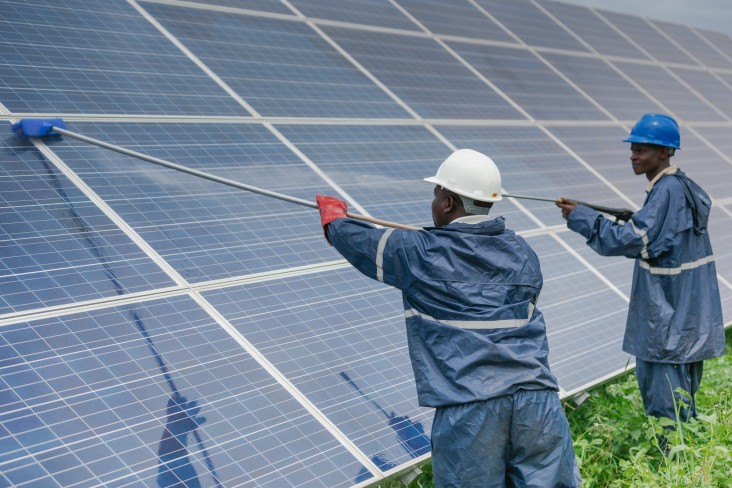 Two men washing solar panels