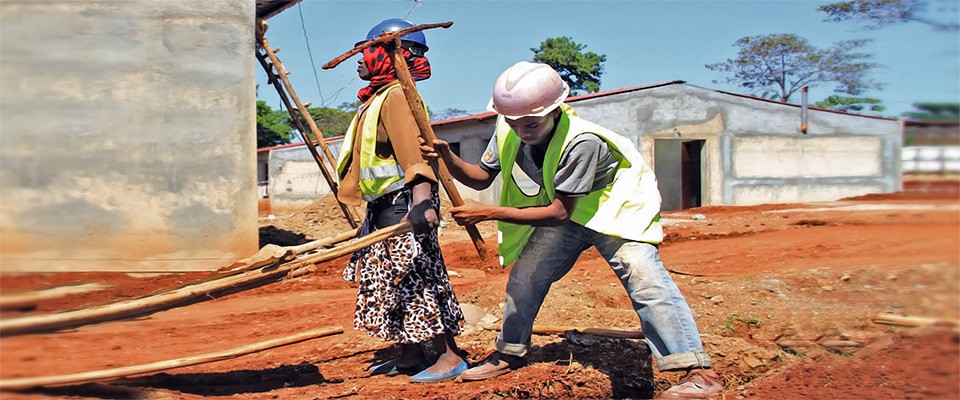 Female and male workers on the construction site of a health facility