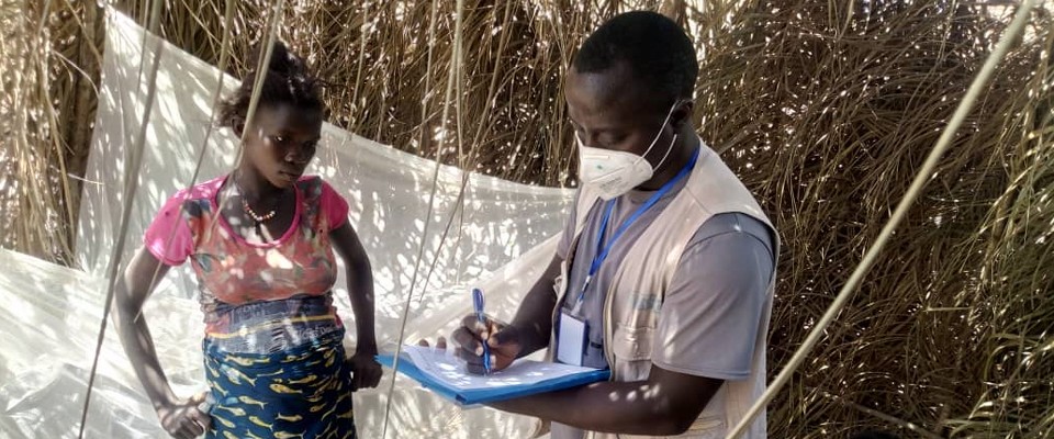 A health worker teaches malaria safety