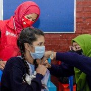 Image of Bangladeshi student receiving Pfizer COVID-19 vaccine