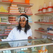 Angatu Ayansa, an employee of the Bako Farm Service Center, helps a customer in selecting merchandise.