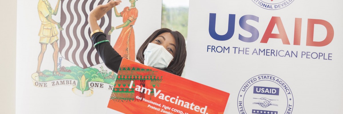 A women celebrates after getting vaccinated at an outreach event.