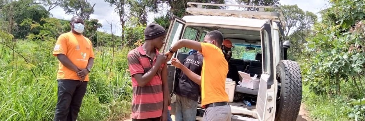 Providing COVID-19 vaccines to workers out of the back of a vehicle.